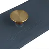 A close-up shot of a blue cast iron pot with a brass knob. Produktbild-Vorschau