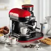 A red and black espresso machine with a grinder, accompanied by coffee cups, croissants, and cookies, set on a table. Produktbild-Vorschau