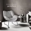 A stylish armchair and sofa in a modern living room setting, with decorative elements on a side table. Náhled obrázku produktu
