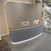 A modern reception desk with two computer monitors in a well-lit, contemporary space. Produktbild-Vorschau