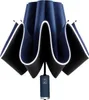 A closed umbrella with a dark blue exterior and black interior, featuring a white trim along the edges. The handle is dark blue with a silver base and a button with an icon. Náhled obrázku produktu