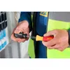 A person wearing a work vest is holding two screwdrivers, one in each hand. Náhľad obrázku produktu