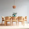 A dining table set with chairs, a vase of flowers, and place settings, illuminated by a pendant lamp. Produktbild-Vorschau