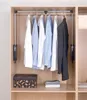 A closet interior with a clothes rail lift system and hanging shirts. Náhled obrázku produktu