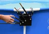 A close-up of a pool accessory attached to the side of a blue pool. A hand is shown interacting with the accessory. Anteprima dell’immagine prodotto