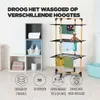 A multi-tiered drying rack with clothes on it, next to storage cubes with towels and toiletries. Informational graphics are at the bottom. Voir les images du produit