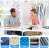 Two people are working at a table with sewing supplies and mannequins in the background. Below the main image are four smaller images of different fabric types. Produktbild-Vorschau