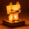 A lit-up Minecraft fox figurine sitting on a square base. Náhled obrázku produktu