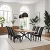 A dining room with a wooden table and chairs, set up for a meal. Náhled obrázku produktu