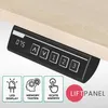 A close-up of a desk control panel mounted under a light wood desk. Produktbild-Vorschau