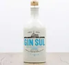 A white ceramic bottle of Gin Sul Dry Gin is placed on a wooden surface against a white background. Anteprima dell’immagine prodotto