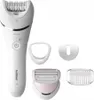 A white Philips epilator with several attachments is displayed against a white background. The epilator is the main focus, with accessories arranged around it. Anteprima dell’immagine prodotto