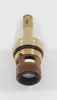 A close-up studio shot of a brass faucet cartridge with ceramic discs. Náhľad obrázku produktu