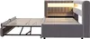 A gray upholstered bed frame with an extended pull-out bed base, showing its internal structure and lighting. Náhled obrázku produktu