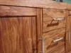 A close-up view of a wooden sideboard with two doors and three drawers. Produktbild-Vorschau