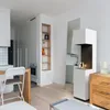 A modern living room with a bioethanol fireplace, a tall mirror, and a wooden dresser. Náhled obrázku produktu
