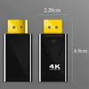 Two black electronic adapters are shown side-by-side against a grey background with measurement lines. Produktbild-Vorschau
