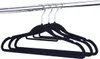 Several black velvet hangers are hanging from a chrome closet rod. Anteprima dell’immagine prodotto