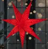 A red star-shaped lantern with white polka dots hangs in front of a window with bokeh lights. Produktbild-Vorschau
