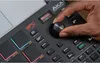 A close-up shot of a person's hand operating a knob on an Akai MPC Studio music production controller. Anteprima dell’immagine prodotto