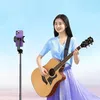 A young woman playing an acoustic guitar while a selfie stick with a phone is positioned to record her. Náhled obrázku produktu