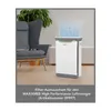 An air purifier is shown in a living room setting next to a chair, with a plant in the background. Produktbild-Vorschau