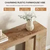 A close-up view of a rustic wooden console table with a vase of flowers and a candle. Produktbild-Vorschau