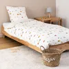 A child's bedroom with a bed, desk, and basket. Náhled obrázku produktu