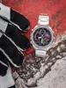 A watch and gloves are placed on a textured surface. Náhled obrázku produktu