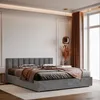 A modern bedroom with a gray upholstered bed. Anteprima dell’immagine prodotto
