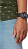 Close-up of a person's wrist wearing a black watch. Produktbild-Vorschau