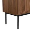 Close-up view of the lower part of a wooden cabinet with black metal legs. Anteprima dell’immagine prodotto