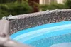 Close-up of the top edge of an above-ground swimming pool with a rattan-like pattern. Produktbild-Vorschau
