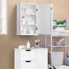 A white bathroom cabinet is shown mounted on a tiled wall, with its door open to reveal shelves stocked with toiletries. Below it, a white bathroom vanity with drawers is visible, and to the right, a white shelving unit holds towels and toiletries next to  Produktbild-Vorschau