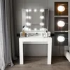 A white vanity table with a tri-fold mirror and LED lights, featuring various cosmetic products on its surface. Náhled obrázku produktu