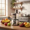 A food processor and a bowl of fruit are displayed on a kitchen counter. Produktbild-Vorschau