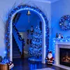 A festive Christmas decoration scene in a home, featuring blue lights, a Christmas tree, and a fireplace. Produktbild-Vorschau