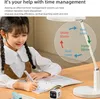 A young girl is studying at a desk with a timer and a lamp. Produktbild-Vorschau