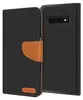 A black flip case for a Samsung Galaxy S10 phone, with a brown leather accent and a small logo.
