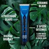 A blue and black hair trimmer is shown against a background of large green leaves with water droplets. Produktbild-Vorschau