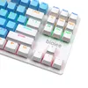 A close-up, angled view of a white mechanical keyboard with blue and white keycaps. Produktbild-Vorschau