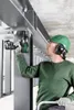 A construction worker using a power tool on a steel structure. Voir les images du produit