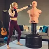 A woman is punching a BOB dummy in a living room. Podgląd zdjęcia produktu