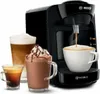 A Bosch Tassimo coffee machine is shown with three different coffee drinks in front of it. Náhľad obrázku produktu