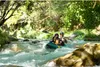 Two people kayaking down a river in a natural setting. Voir les images du produit