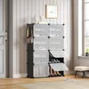 A shoe rack with shoes and bags in a room with a door and window. Produktbild-Vorschau