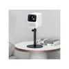 A white projector is mounted on a black stand on a white table, next to two books. Anteprima dell’immagine prodotto