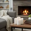 A cozy living room scene with a fireplace, sofa, and a coffee table with LED candles. Produktbild-Vorschau
