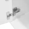 A close-up view of a cabinet hinge on a white surface. Anteprima dell’immagine prodotto