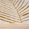 A close-up view of a rug with a leaf pattern. Anteprima dell’immagine prodotto